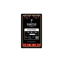 Load image into Gallery viewer, Close-up of Santos Coffee Yellow Bourbon label showing Medium roast, elevation 4,600 ft, and flavor notes of orange, toffee, and chocolate.