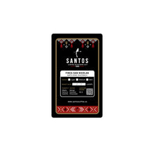 Load image into Gallery viewer, Close-up of Santos Coffee San Nicolás label showing Medium roast, elevation 4,600 ft, and flavor notes of mango, caramel, and chocolate.
